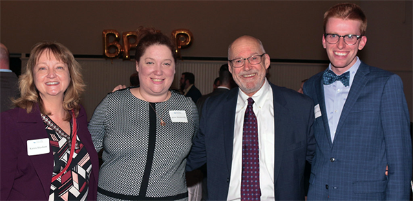 dean Abramovsky poses with other alumni at a BPILP auction