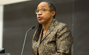photo of miller speaking at a podium