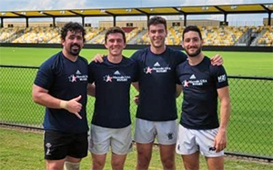 photo of honig with rugby teammates outside in a sports field